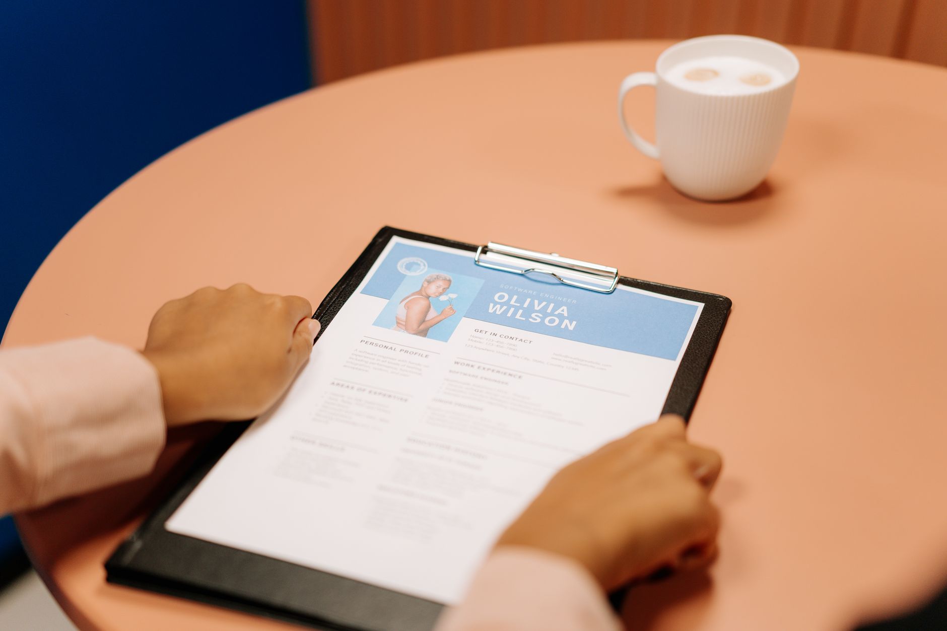 Recruiter checking whether a background check shows education history on a resume