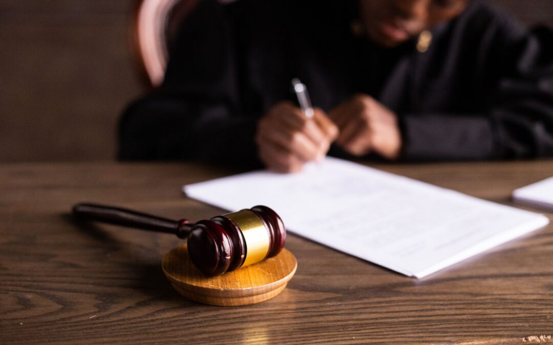 Court gavel and case file illustrating what does disposition date mean on a background check